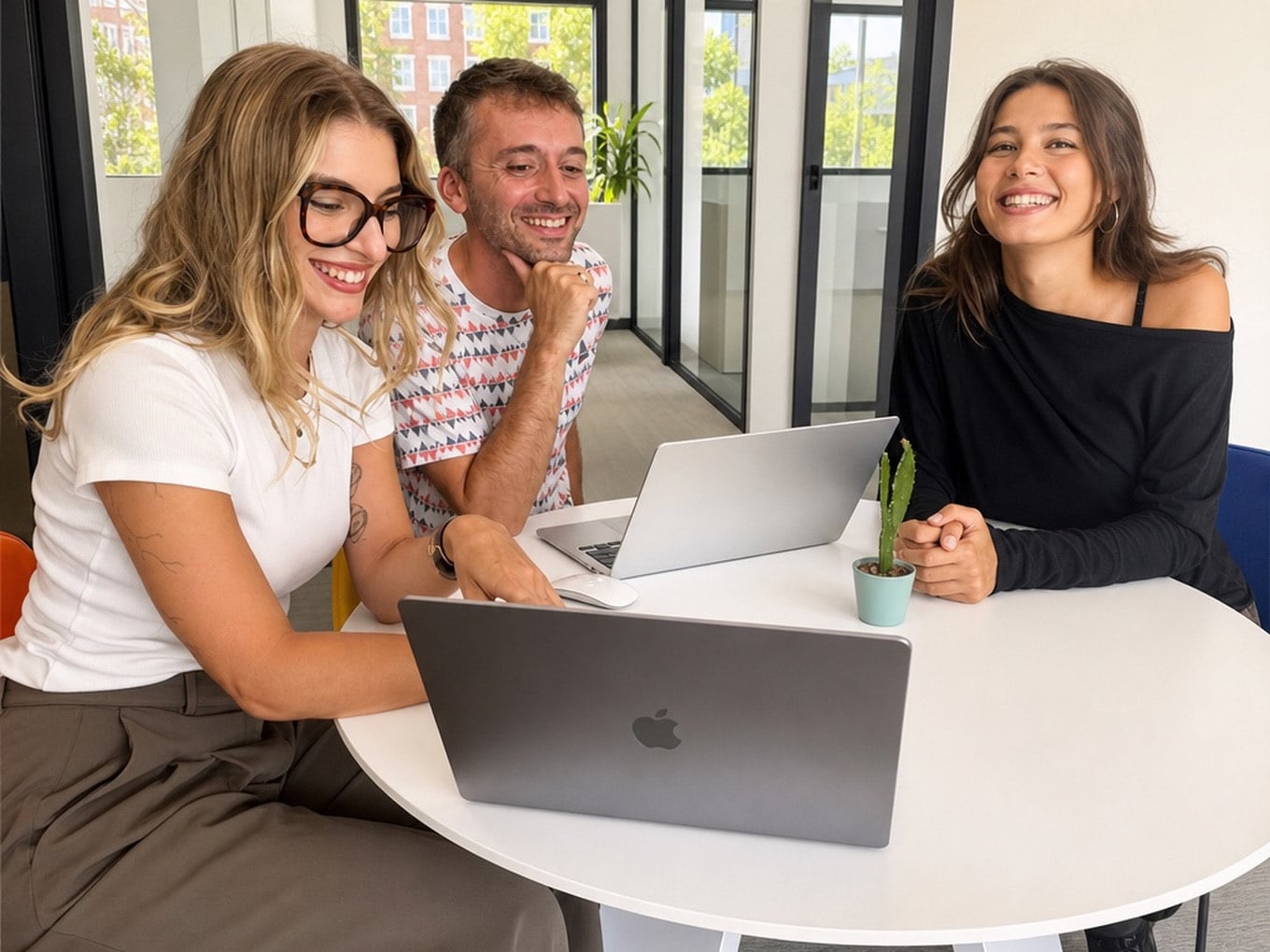 Moment d'échange souriant entre trois membres de l'équipe